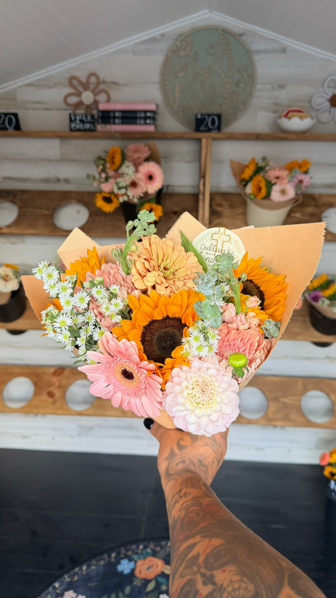A wrapped bouquet of gerbera daisies, dahlias and mums from the flower shed